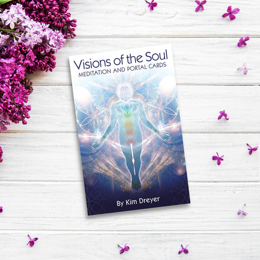 The product name is already correctly integrated into the sentence provided:
"A book titled "Visions of the Soul: Meditation and Portal Cards" by Kim Dreyer lies on a white wooden surface adorned with scattered purple flowers. The cover features an ethereal figure surrounded by colorful, mystical patterns—an exquisite oracle deck for spiritual seekers. Purple flowers are placed on the left.