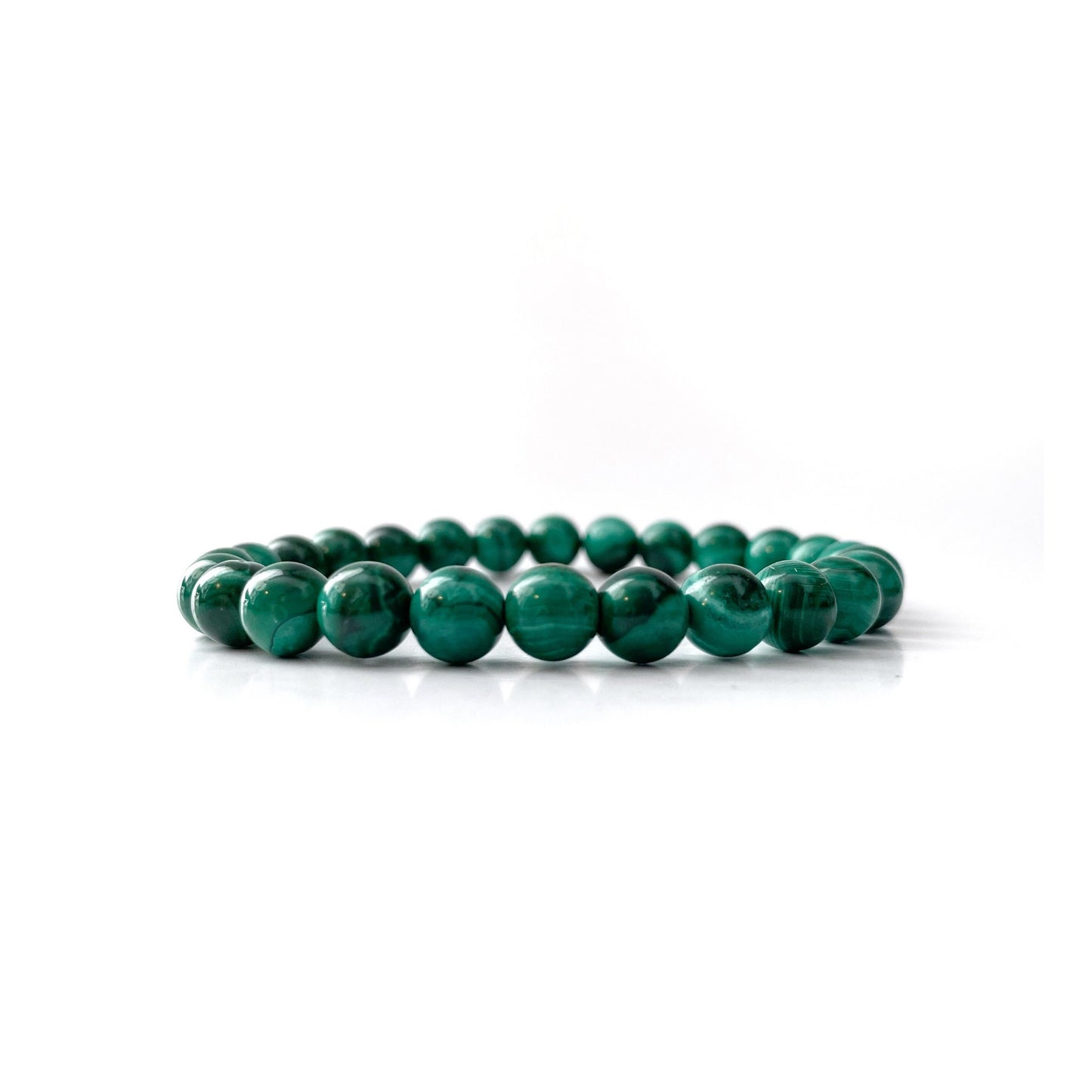 A stack of three 8mm Genuine Malachite Beaded Bracelets displayed on a plain white background. Each bracelet features round, polished beads with natural light and dark green banding and swirls, characteristic of this malachite protection stone.
